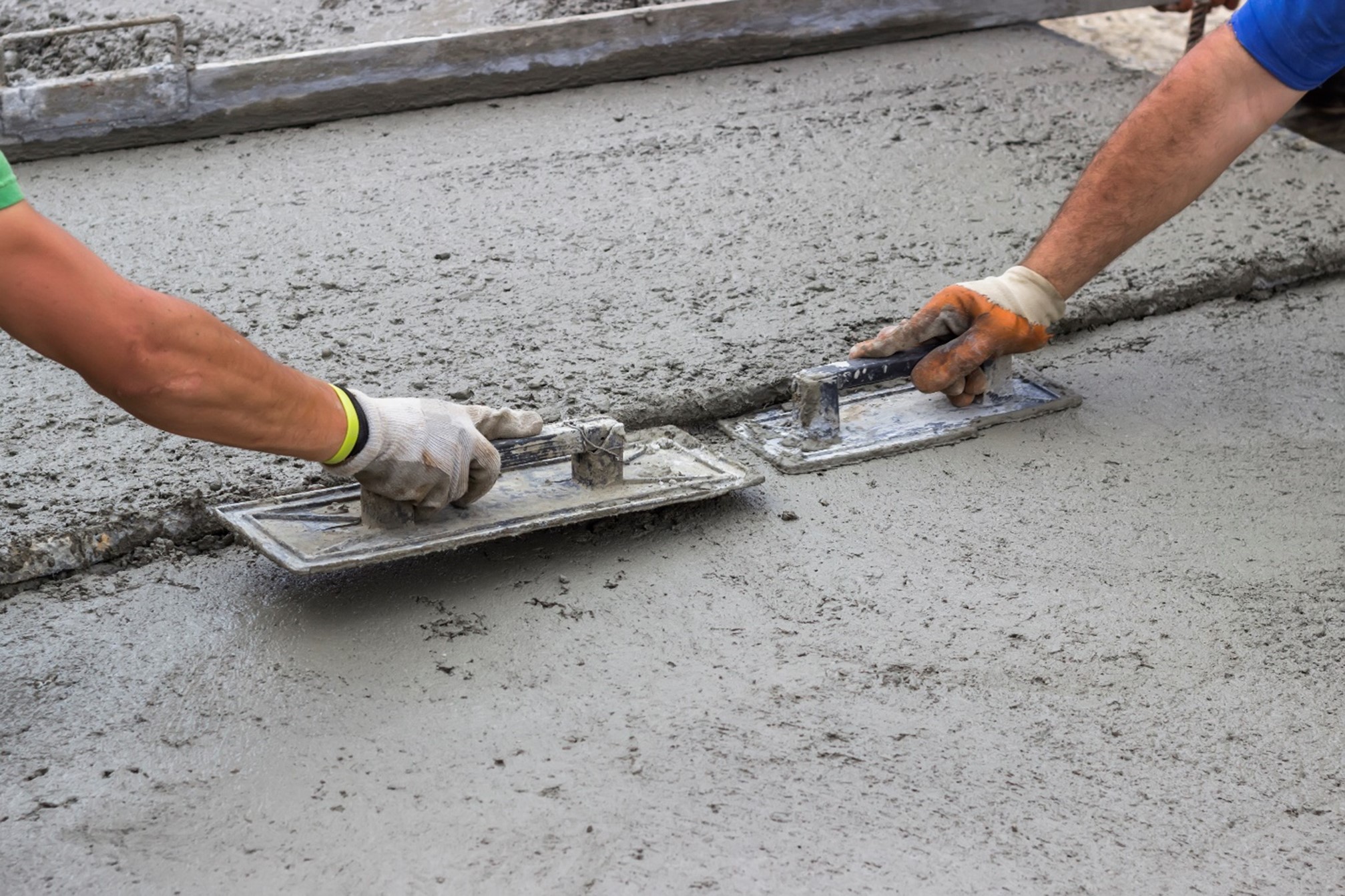 A close-up of a person using a trowel