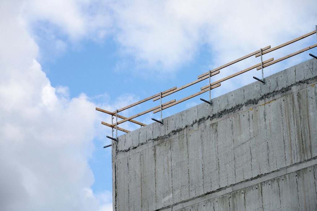 A concrete wall with a railing